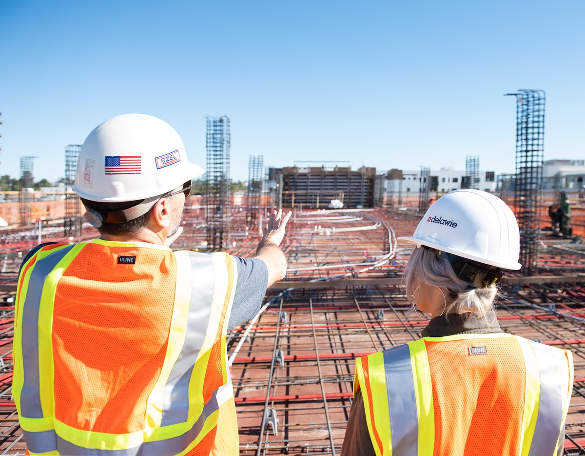 Construction project manager and superintendent on top of building